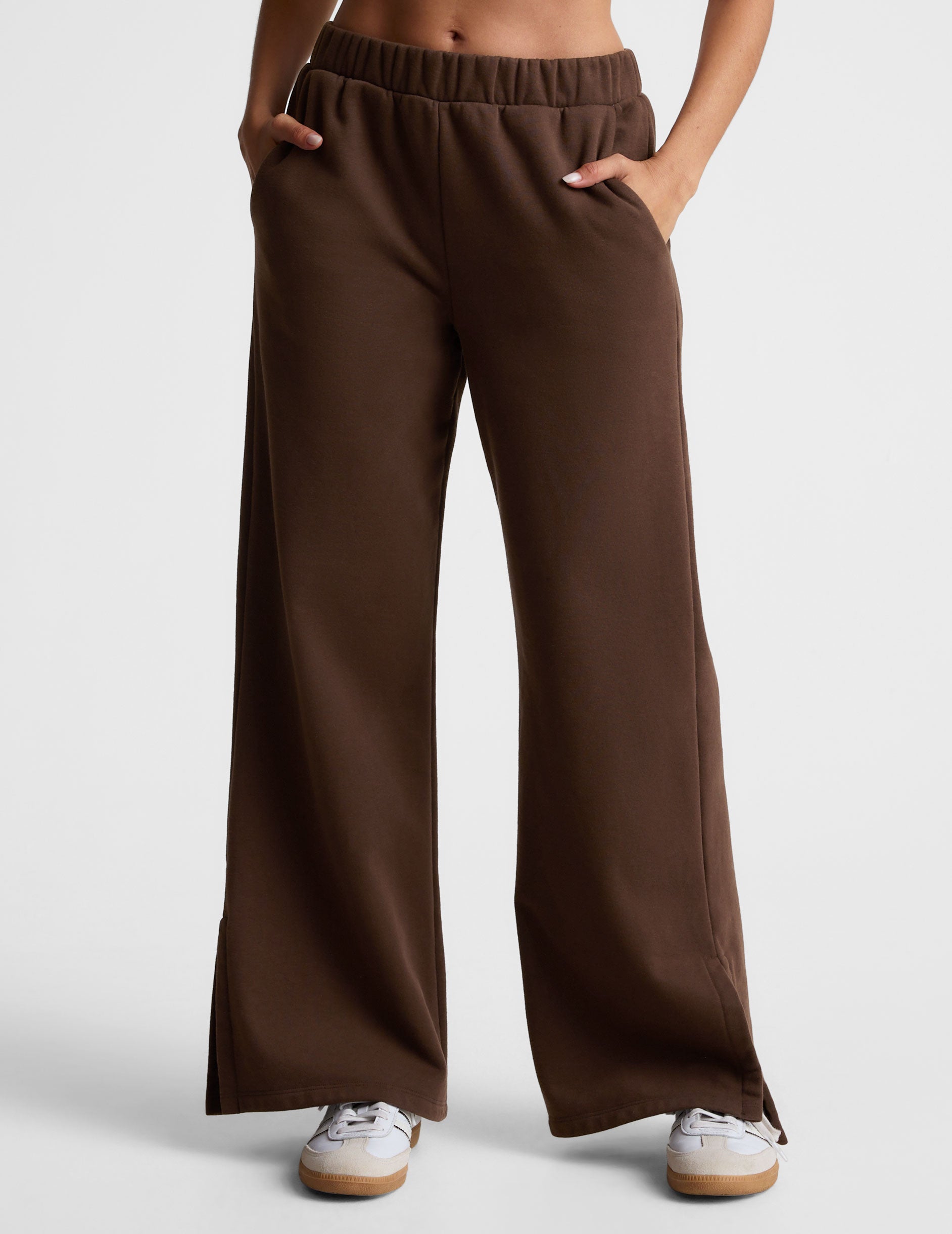 brown mid-rise, wide leg fleece sweatpants with side slits at the ankle and pockets. 