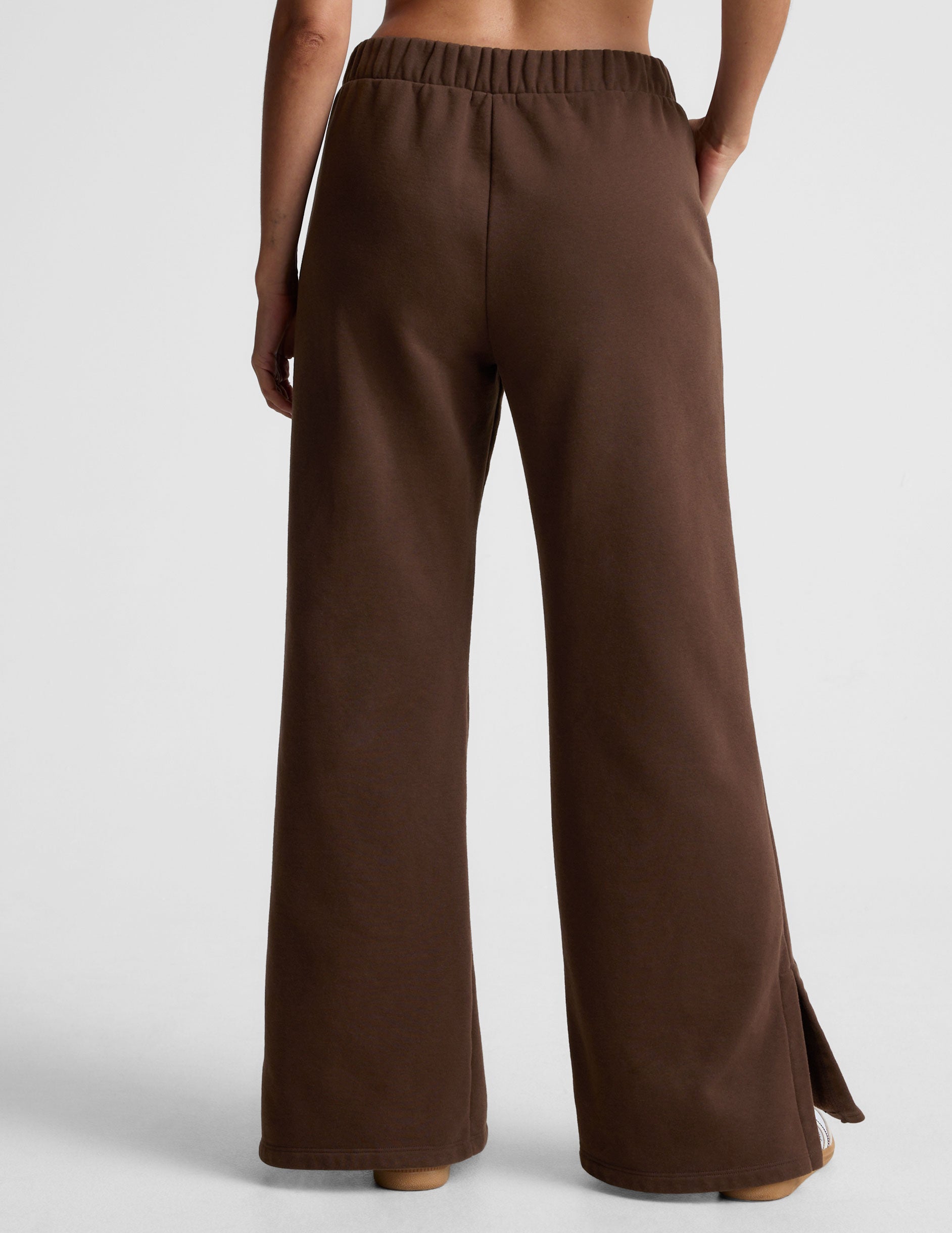 brown mid-rise, wide leg fleece sweatpants with side slits at the ankle and pockets. 