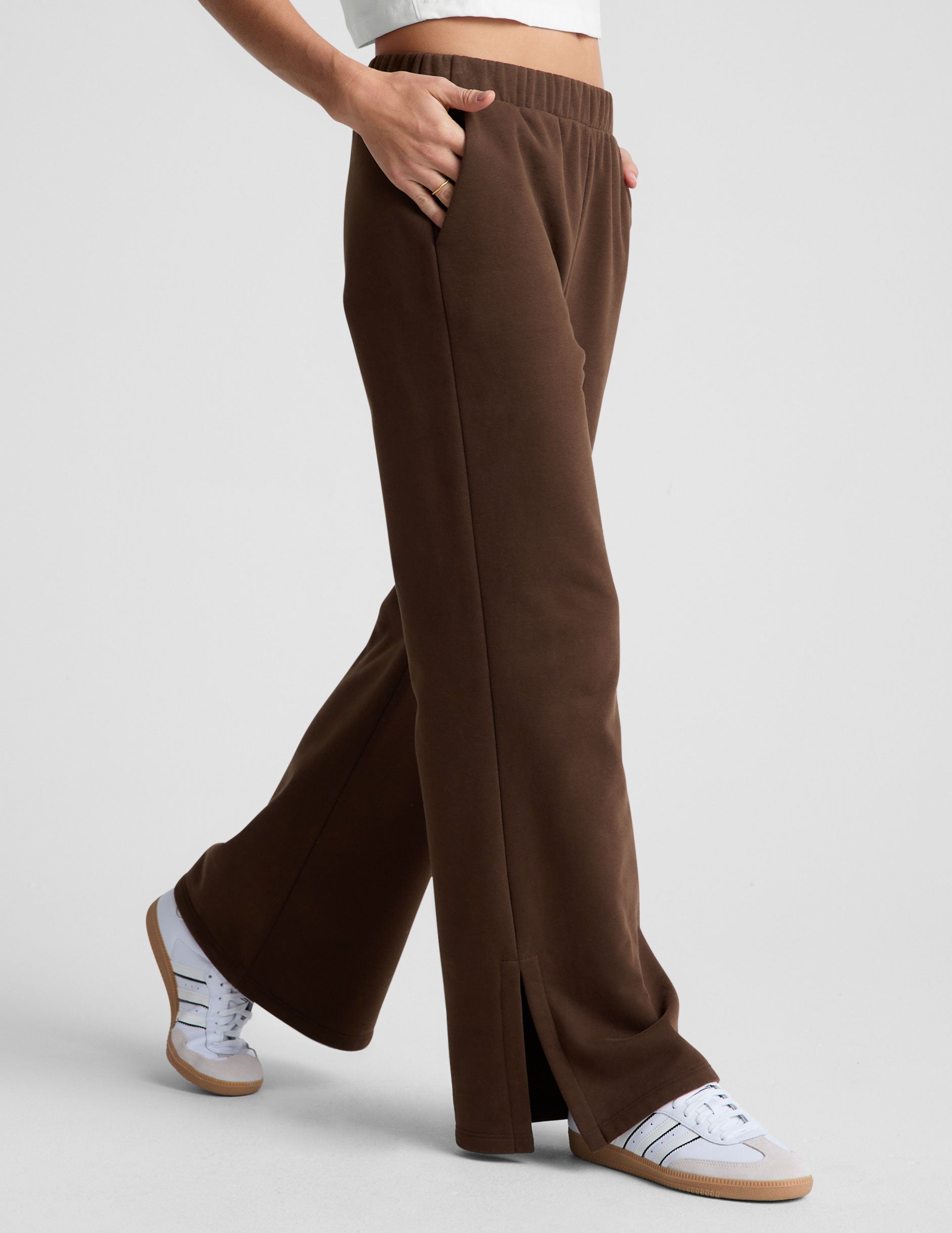 brown mid-rise, wide leg fleece sweatpants with side slits at the ankle and pockets. 