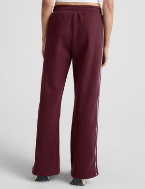 red sweatpant with a mid rise elasticated waistband and contrast piping trim down sides of leg. 