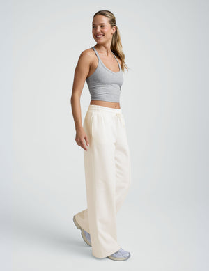 model wearing a grey tank and white fleece wide leg pants against a plain background. 