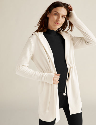 white jacket with drawstring at waist. 