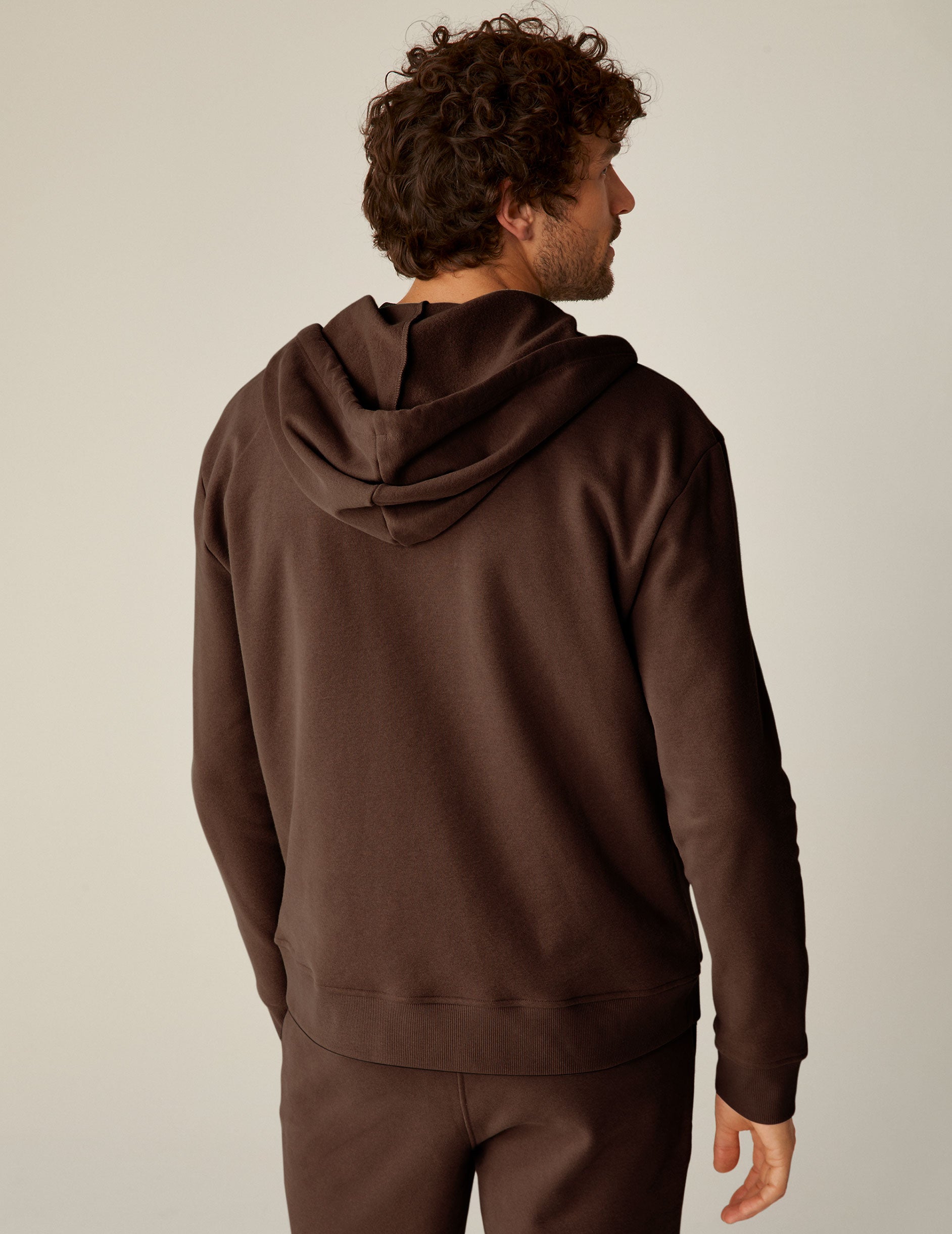 brown zip-up jacket with pockets and a hood. 