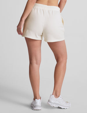 white sweat shorts with pockets and a drawstring at waistband. 