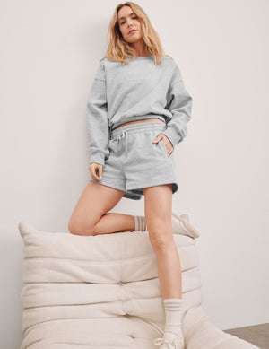 gray sweat shorts with pockets and a drawstring at waistband. 