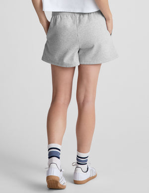 gray sweat shorts with pockets and a drawstring at waistband. 