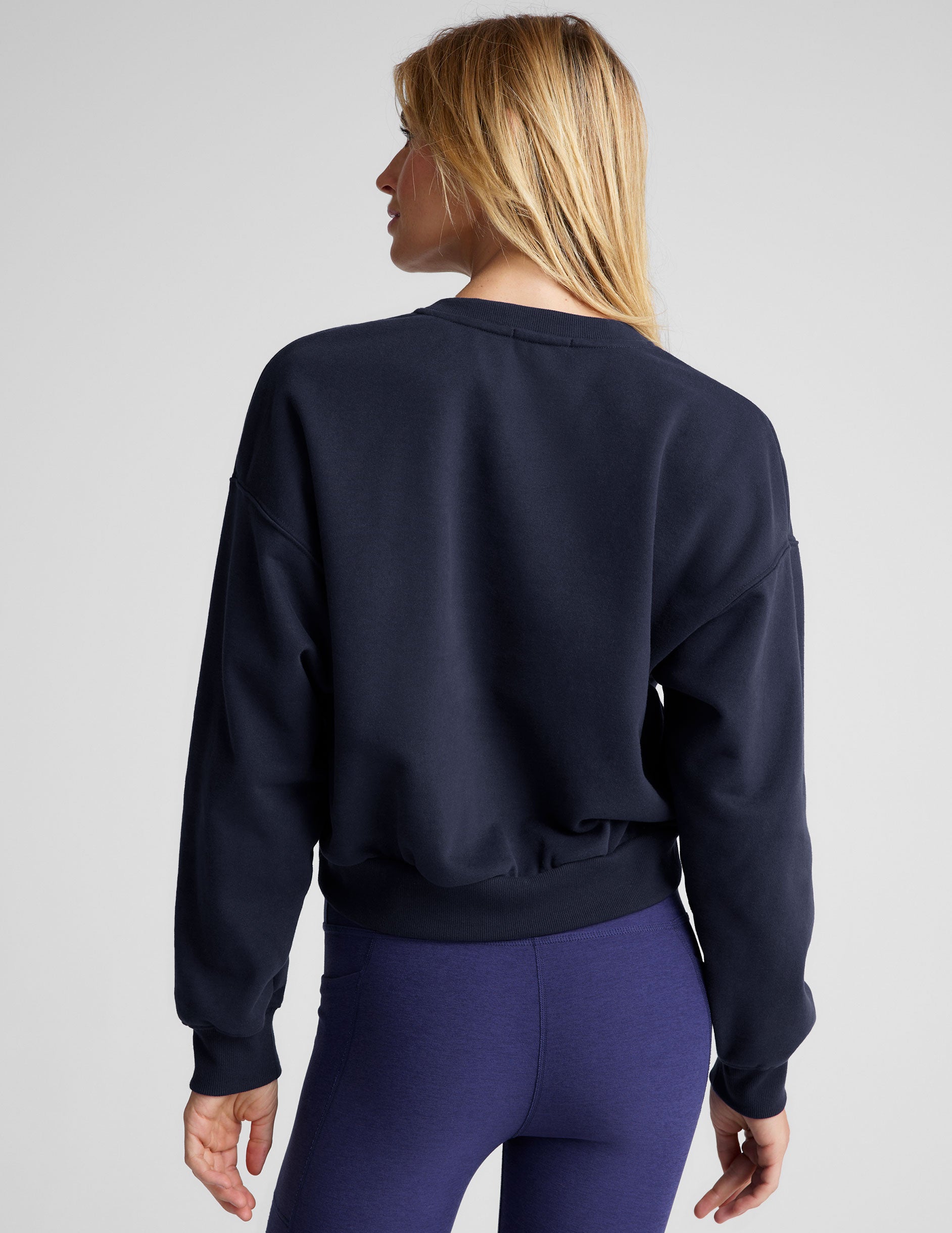 blue loose-fitting classic length crew neck sweatshirt. 