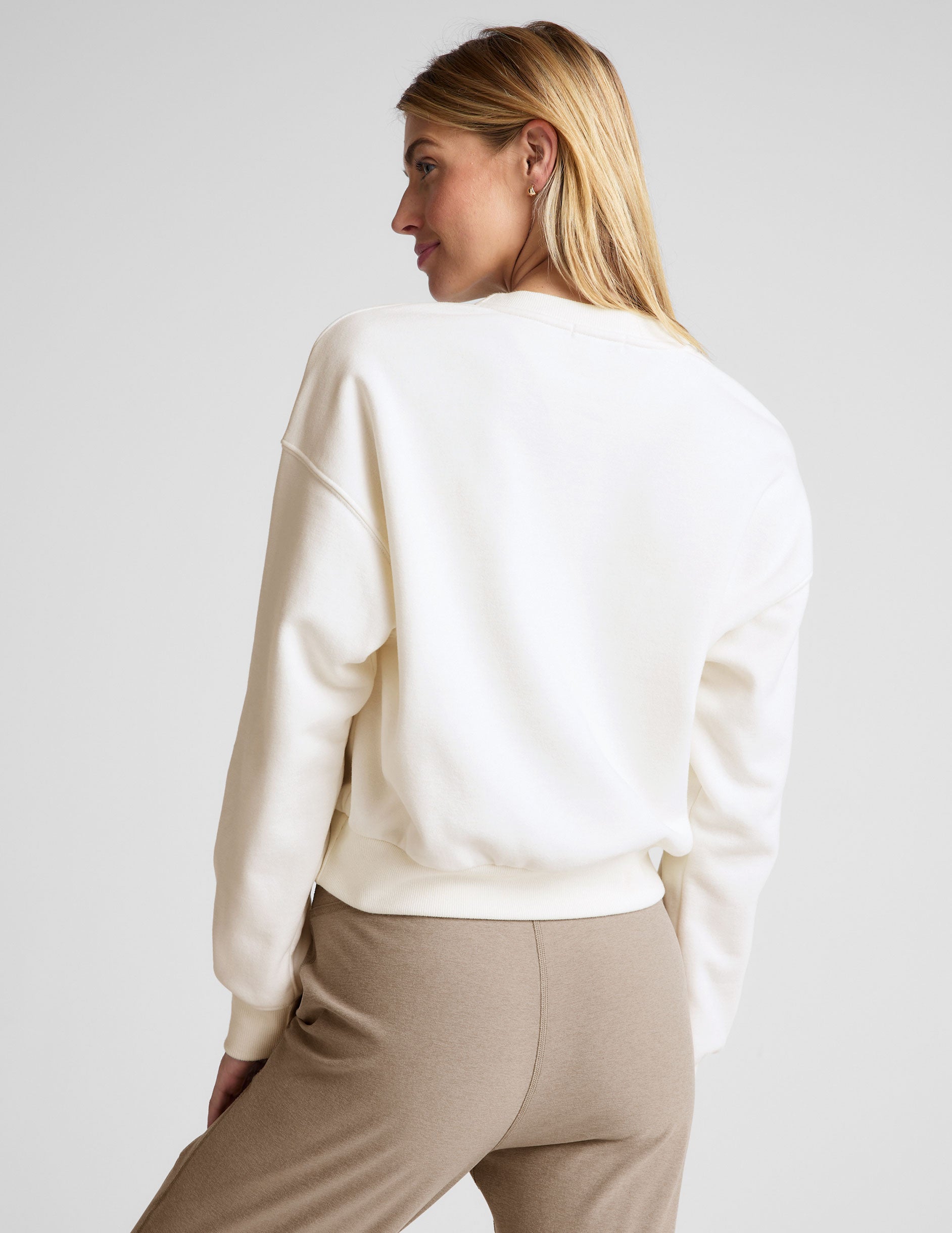 white loose-fitting classic length crew neck sweatshirt. 