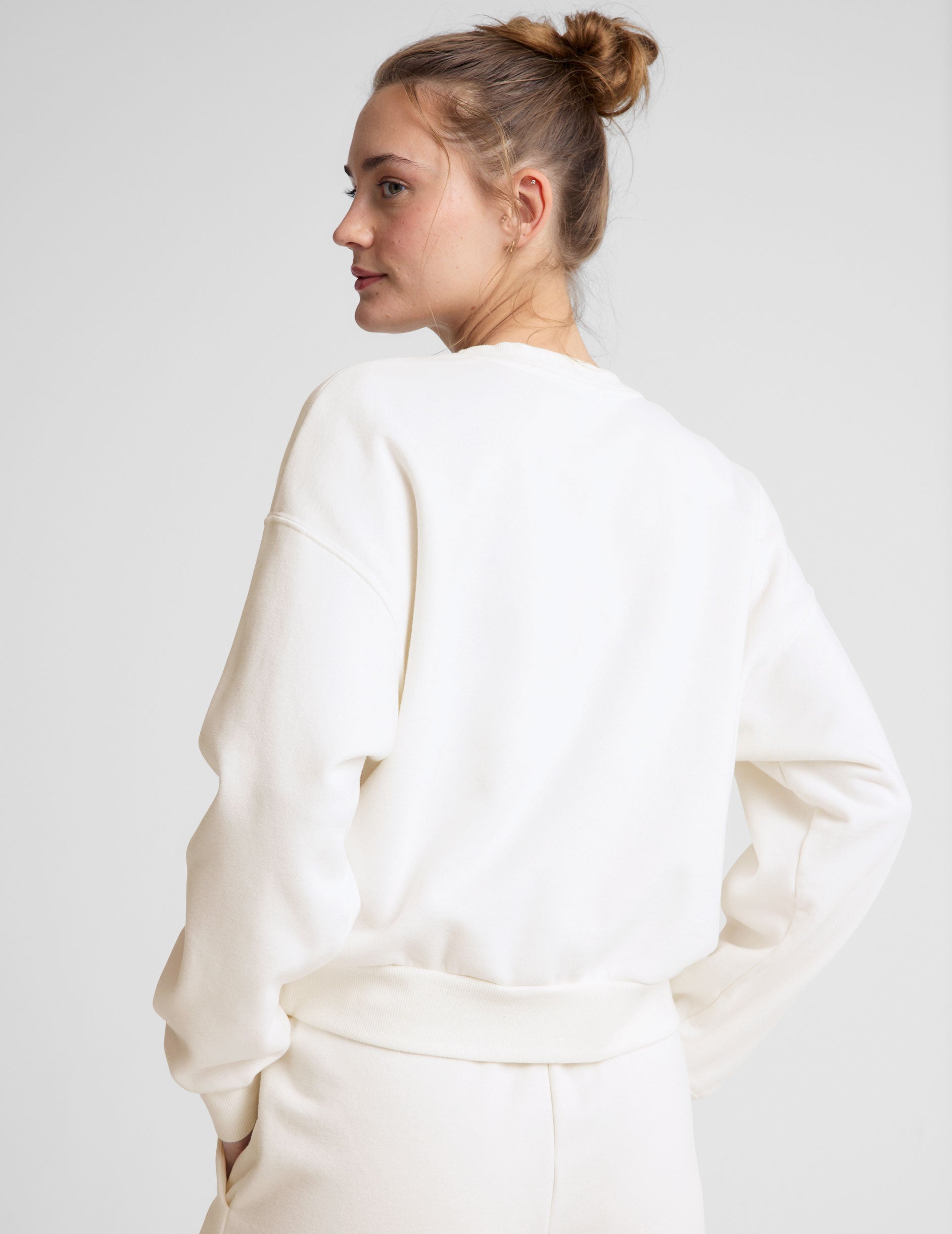 white loose-fitting classic length crew neck sweatshirt. 