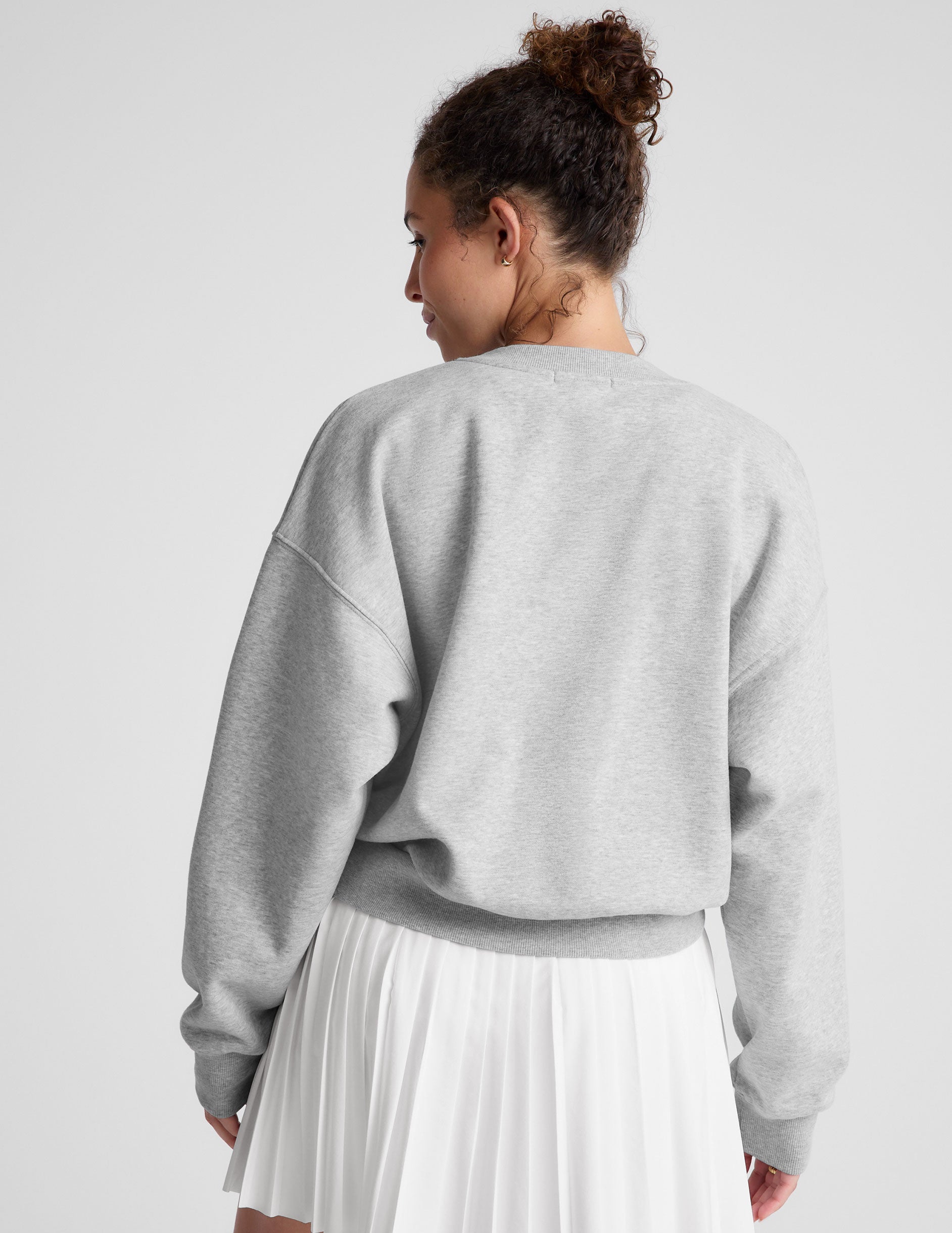 gray loose-fitting classic length crew neck sweatshirt. 