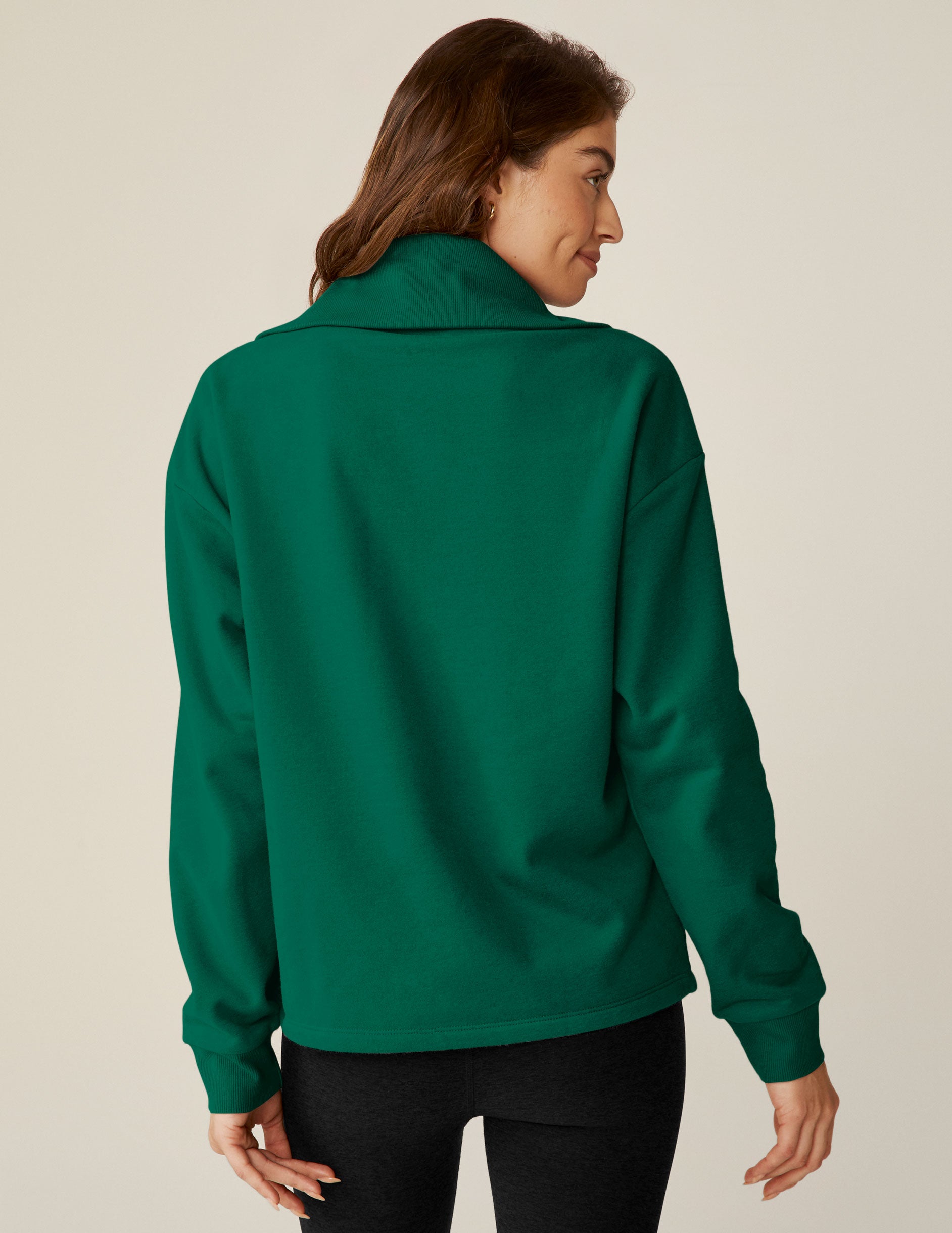 green quarter zip pullover jacket with a kangaroo pouch.