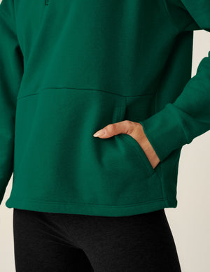 green quarter zip pullover jacket with a kangaroo pouch.