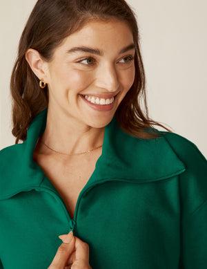 green quarter zip pullover jacket with a kangaroo pouch.