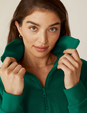 green quarter zip pullover jacket with a kangaroo pouch.