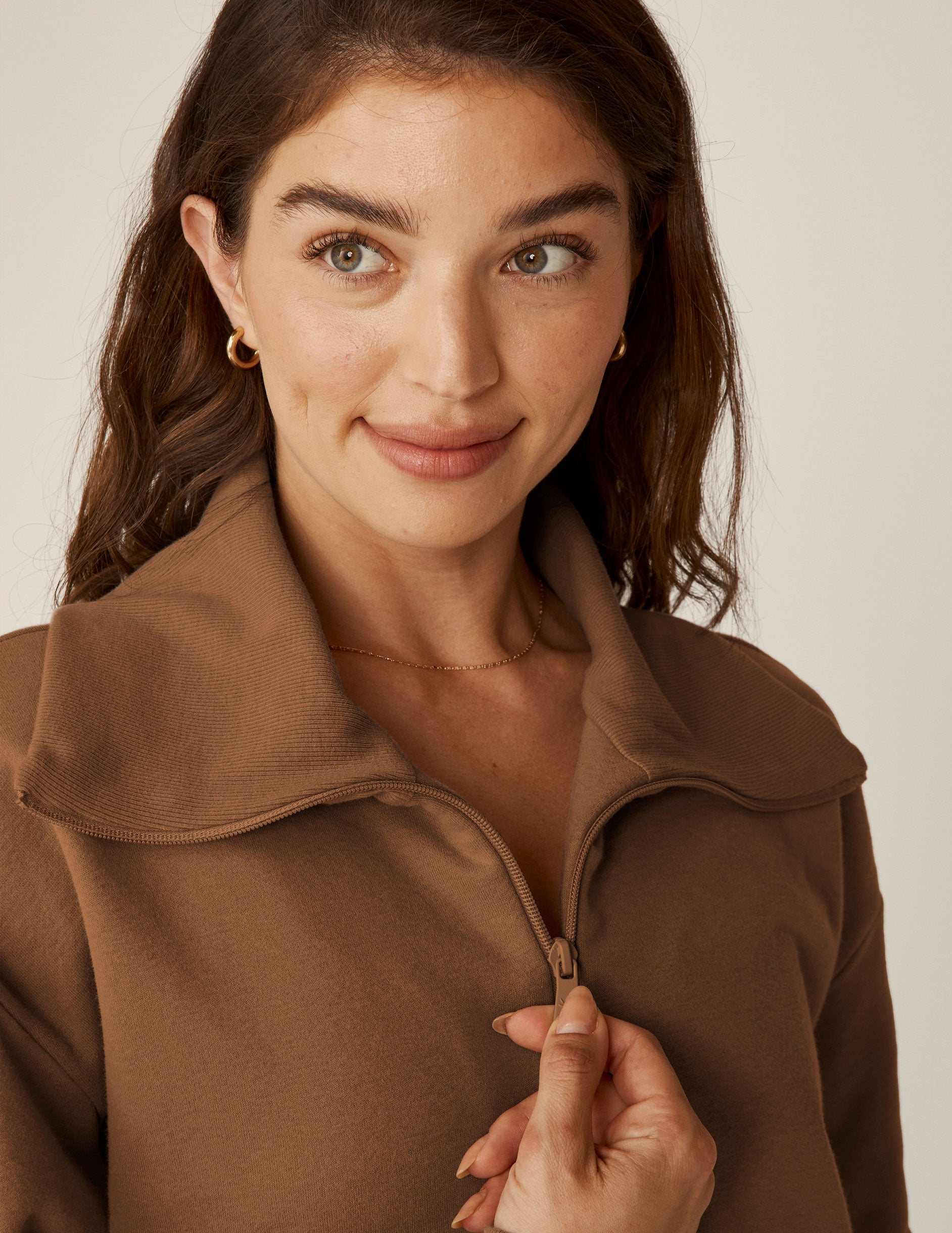 brown quarter zip pullover with kangaroo pocket. 