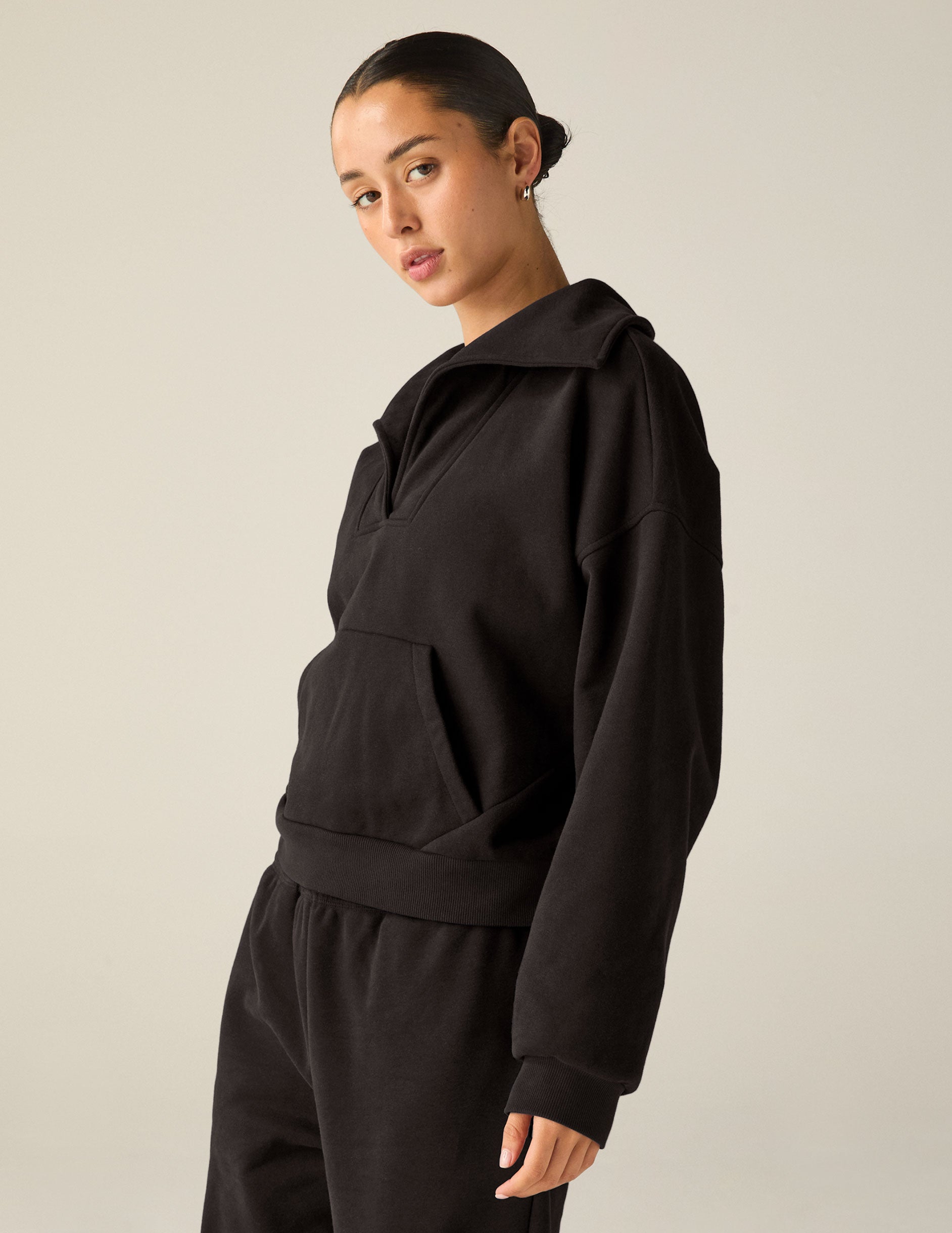 black pullover with a collar and kangaroo pocket. 