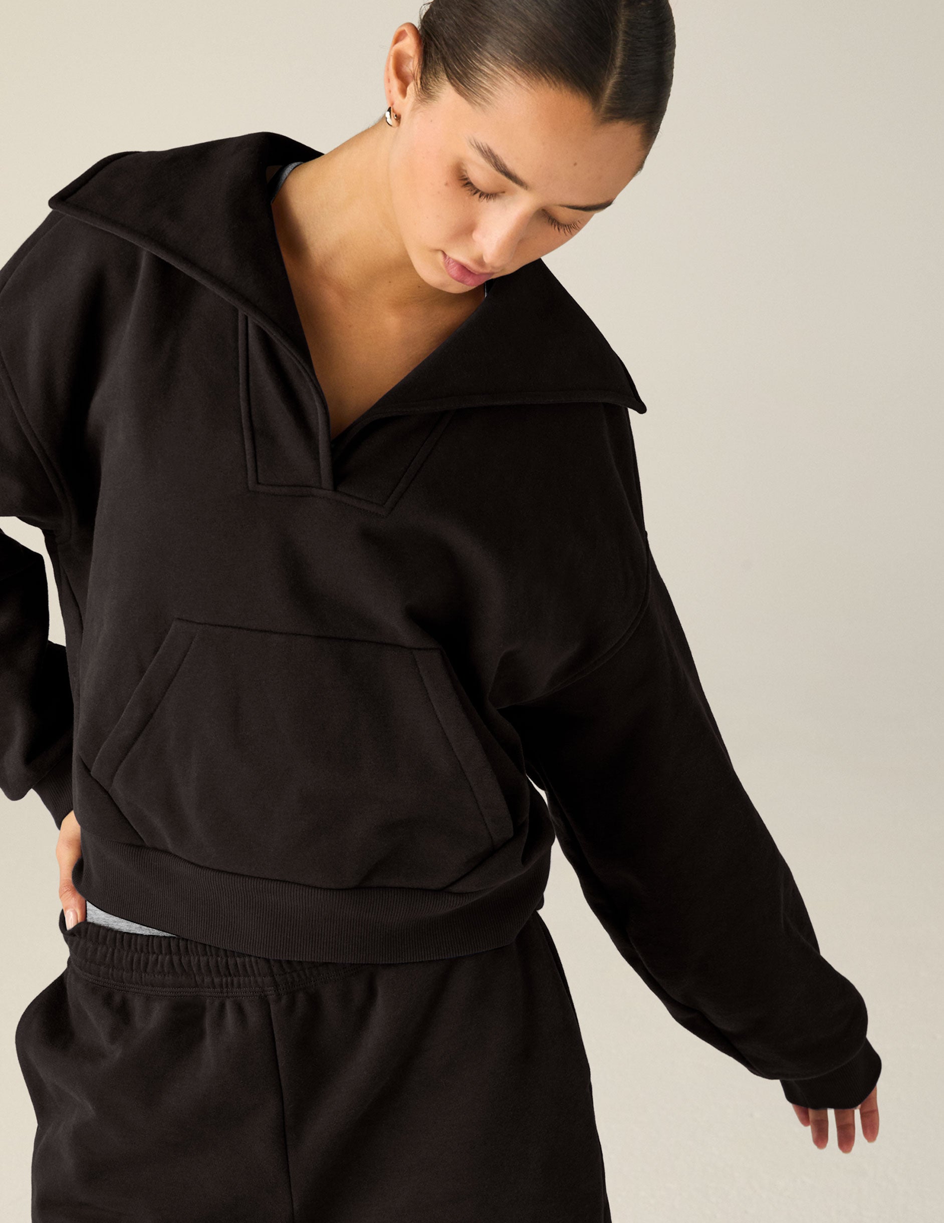 black pullover with a collar and kangaroo pocket. 