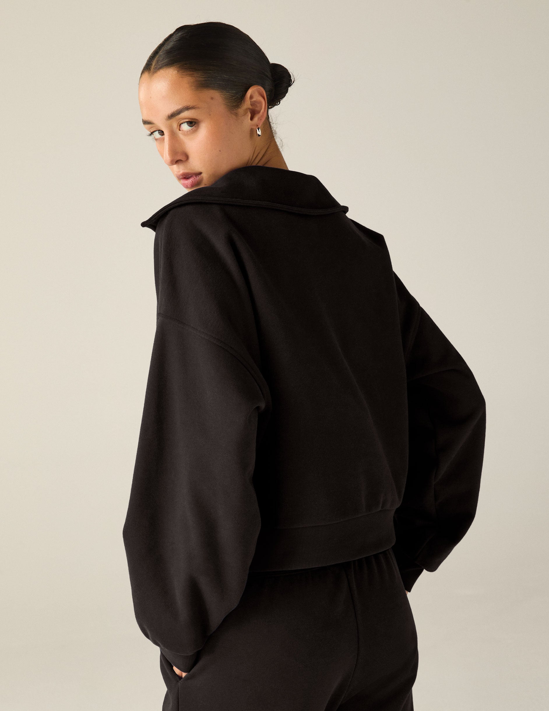 black pullover with a collar and kangaroo pocket. 