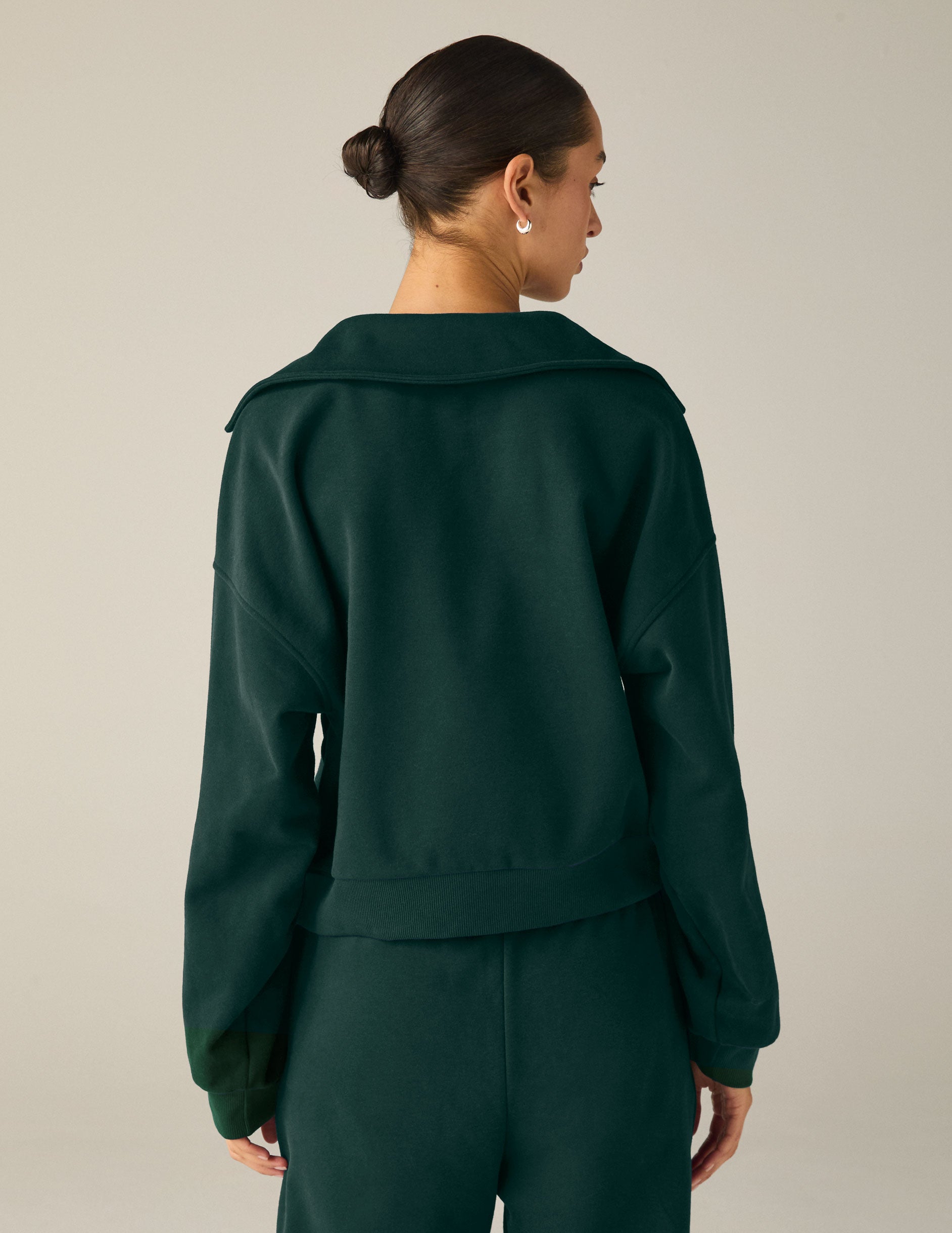 green pullover sweater with a collar and kangaroo pocket. 