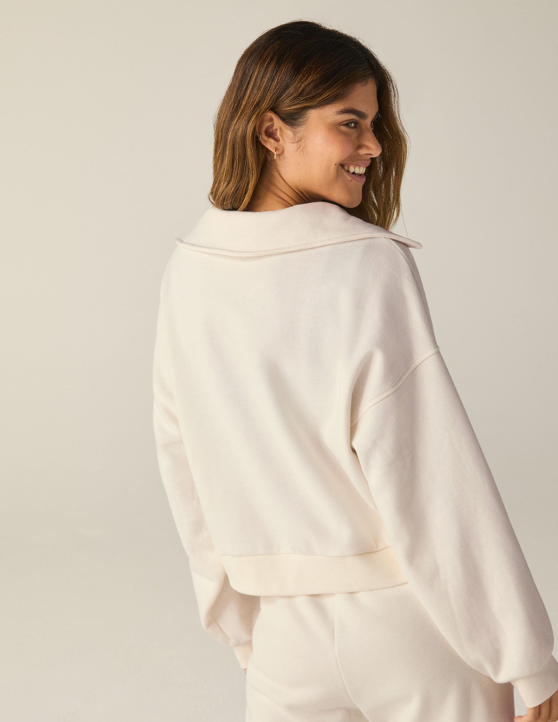 white pullover sweatshirt with a collar and kangaroo pocket. 