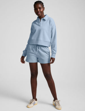 blue cropped long sleeve pullover with a v-neck collared neckline. 