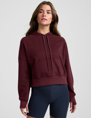 red cropped pullover with a hood with drawcord and a kangaroo pocket. 