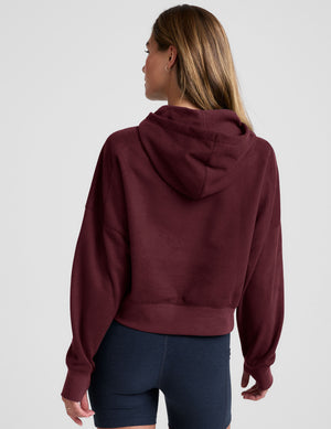 red cropped pullover with a hood with drawcord and a kangaroo pocket. 