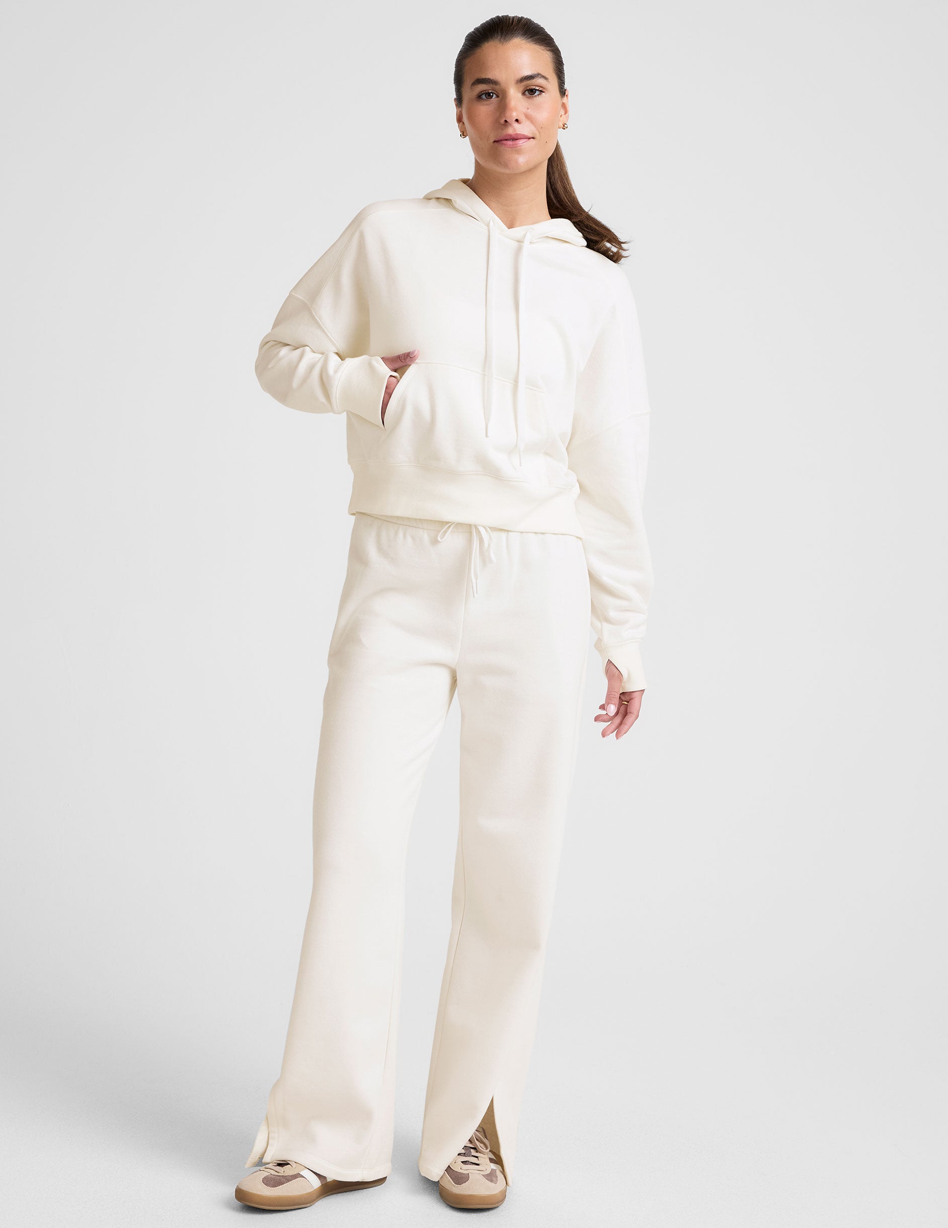 white cropped pullover with a hood with drawcord and a kangaroo pocket. 