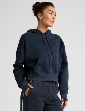blue cropped pullover with a hood with drawcord and a kangaroo pocket. 