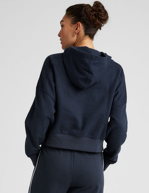 blue cropped pullover with a hood with drawcord and a kangaroo pocket. 