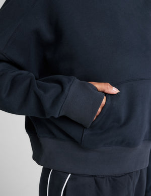 blue cropped pullover with a hood with drawcord and a kangaroo pocket. 