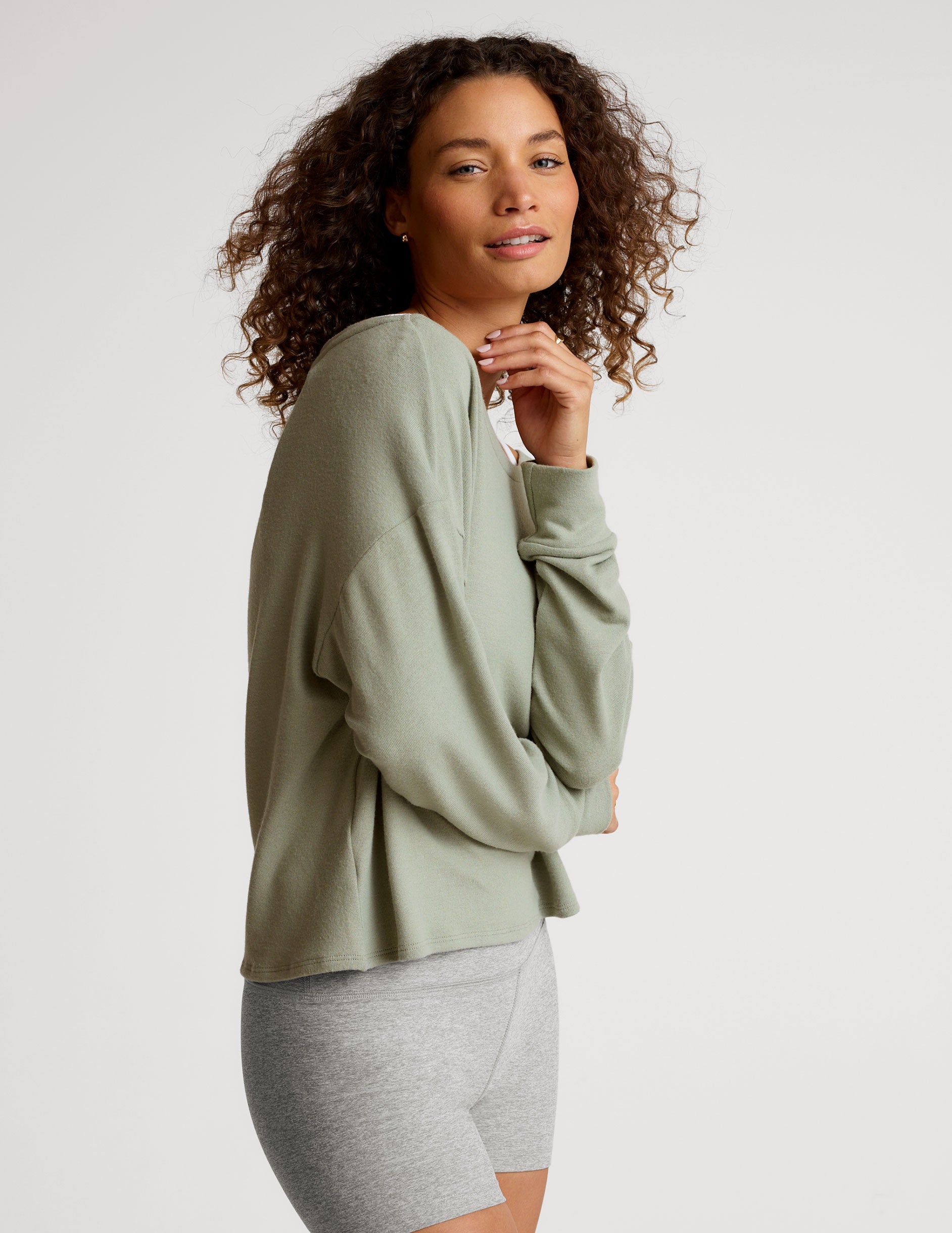 green classic length long sleeve sweater with a wide off-the-shoulder neckline. 