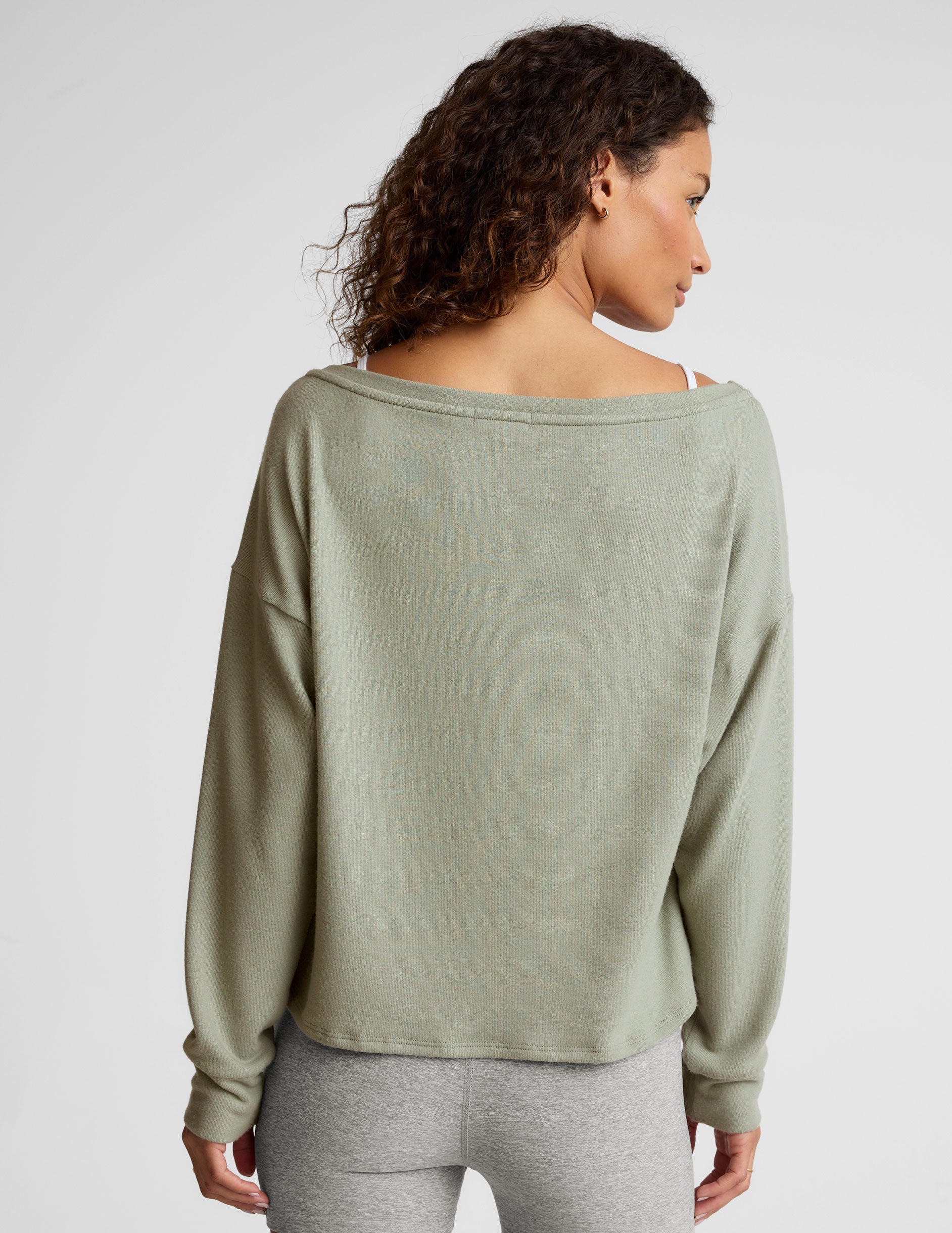 green classic length long sleeve sweater with a wide off-the-shoulder neckline. 