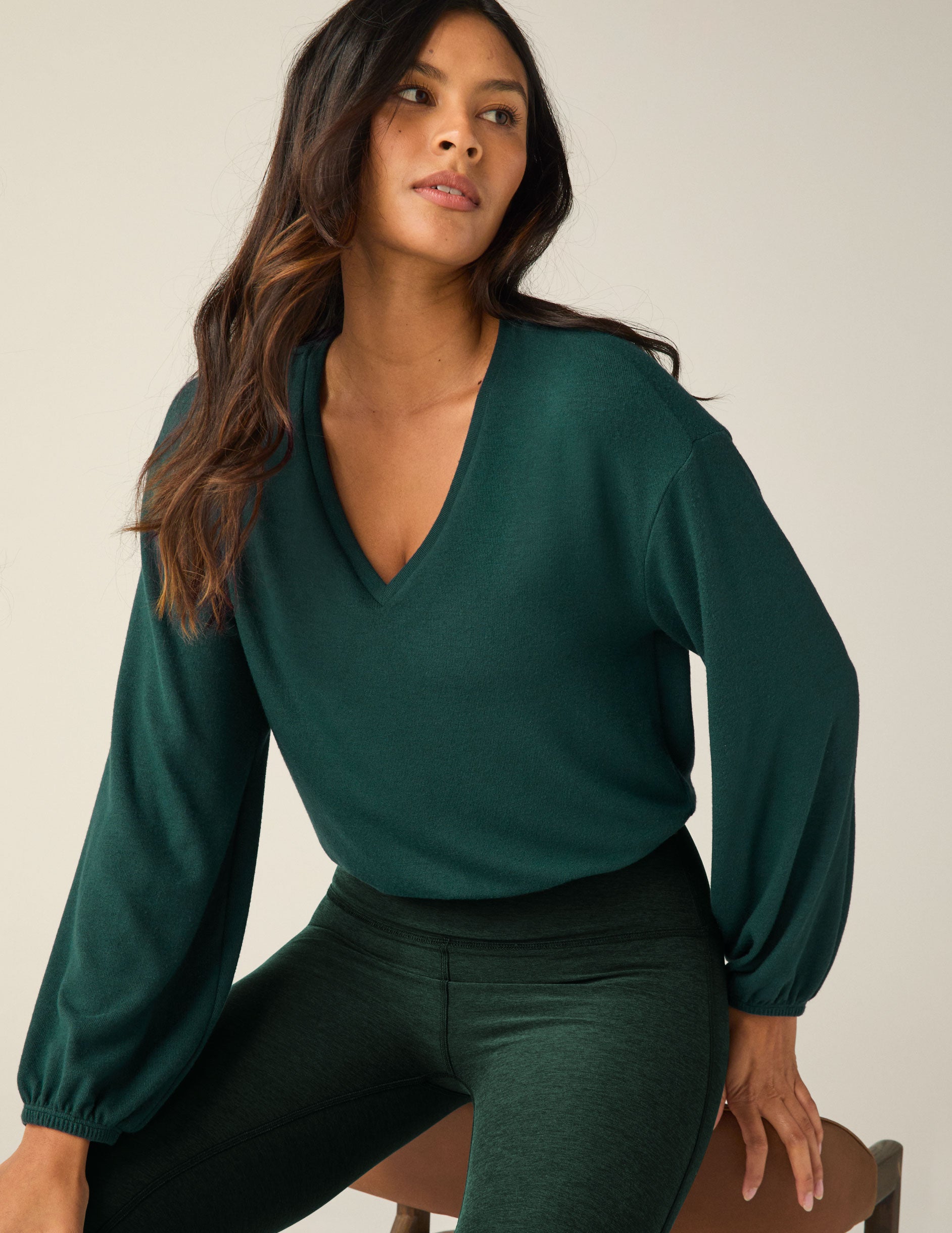 green v-neck pullover.