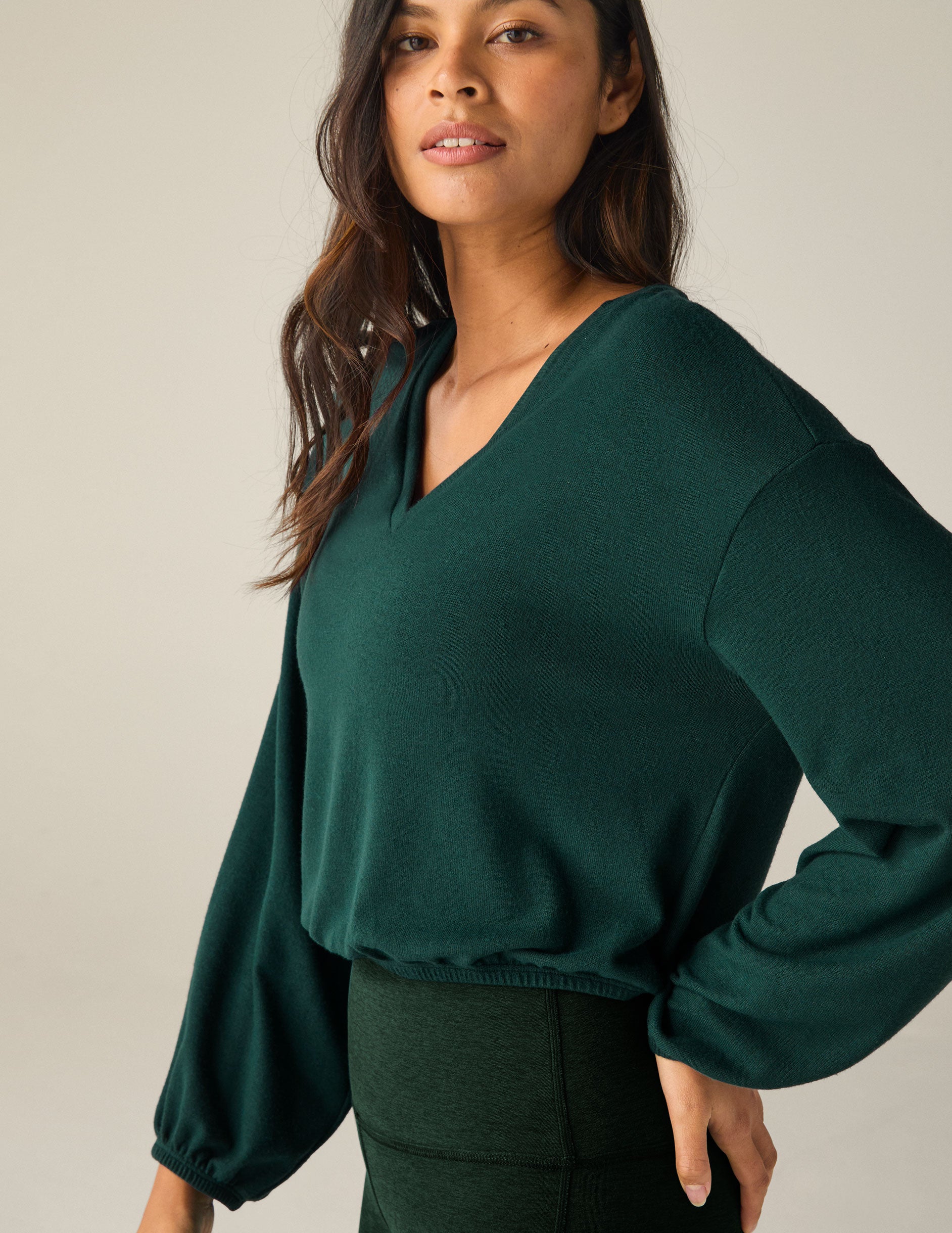 green v-neck pullover.