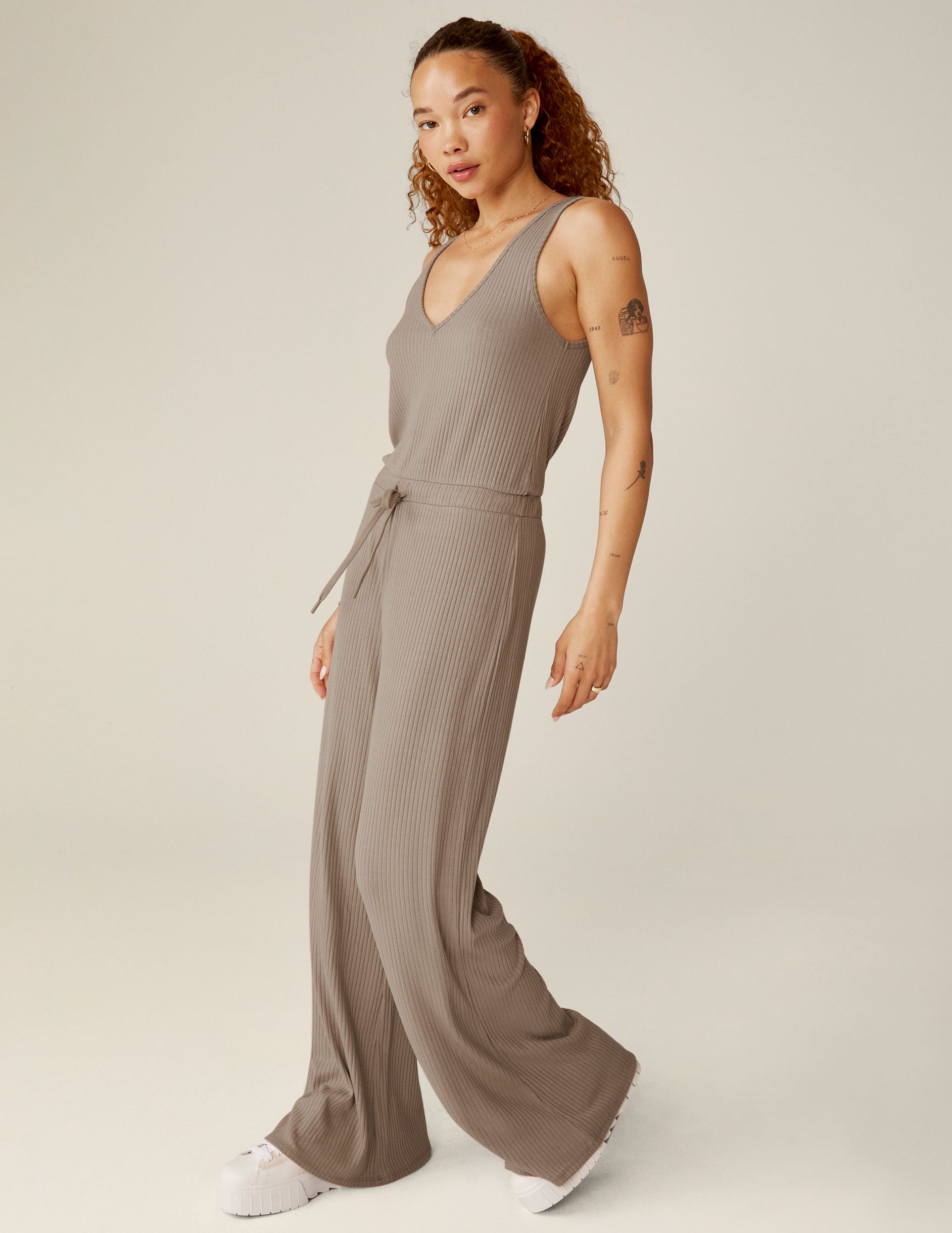 brown ribbed v-neck jumpsuit with a drawstring at waistband. 