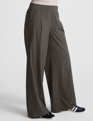 Side view of the gray Easy Wide Leg Pant featuring a relaxed fit, elastic waist, front pleats, and side pockets.