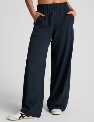 Navy Easy Wide Leg Pant featuring a relaxed fit, elastic waistband, and front pockets, shown on a model.