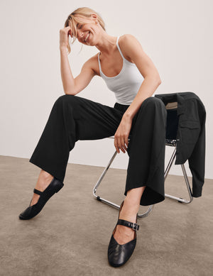 black mid rise relaxed fit wide leg pant with front side seam pockets and back pockets. 