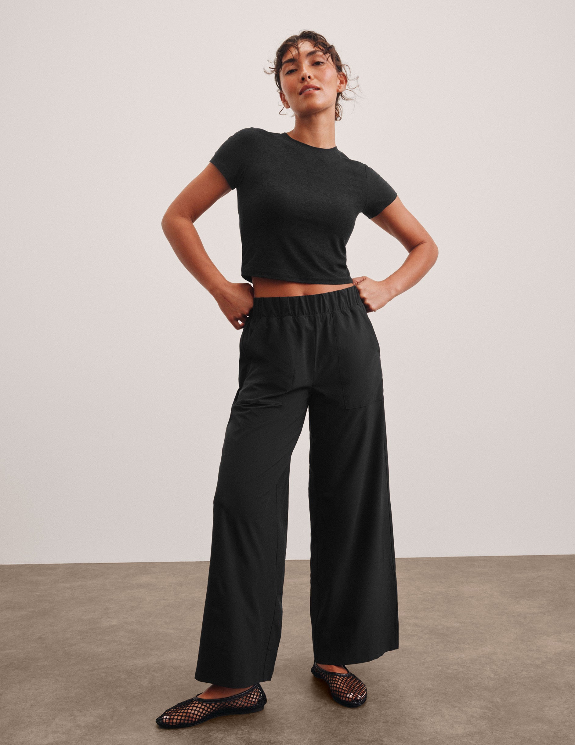 black mid rise relaxed fit wide leg pant with front side seam pockets and back pockets. 