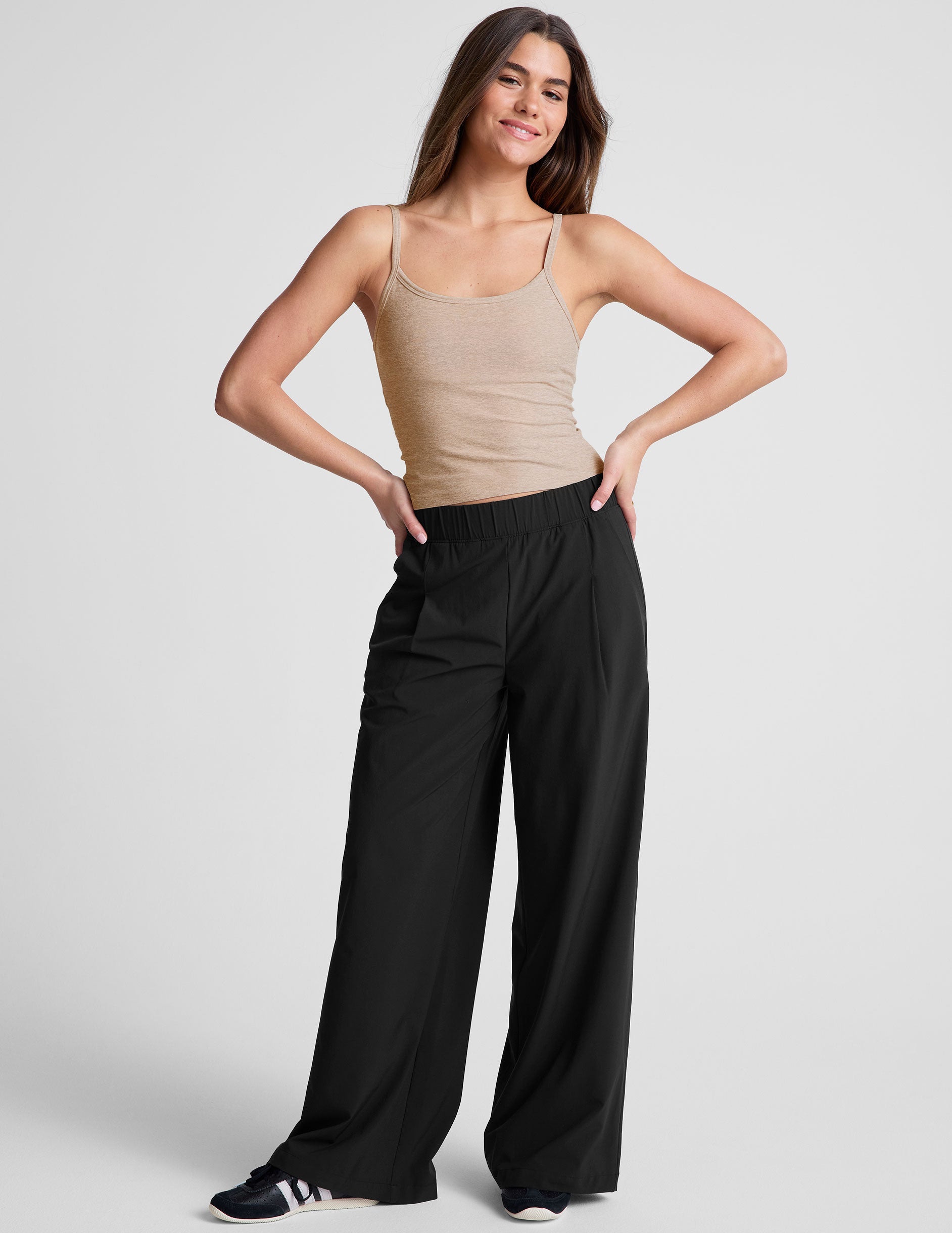 black mid rise relaxed fit wide leg pant with front side seam pockets and back pockets. 