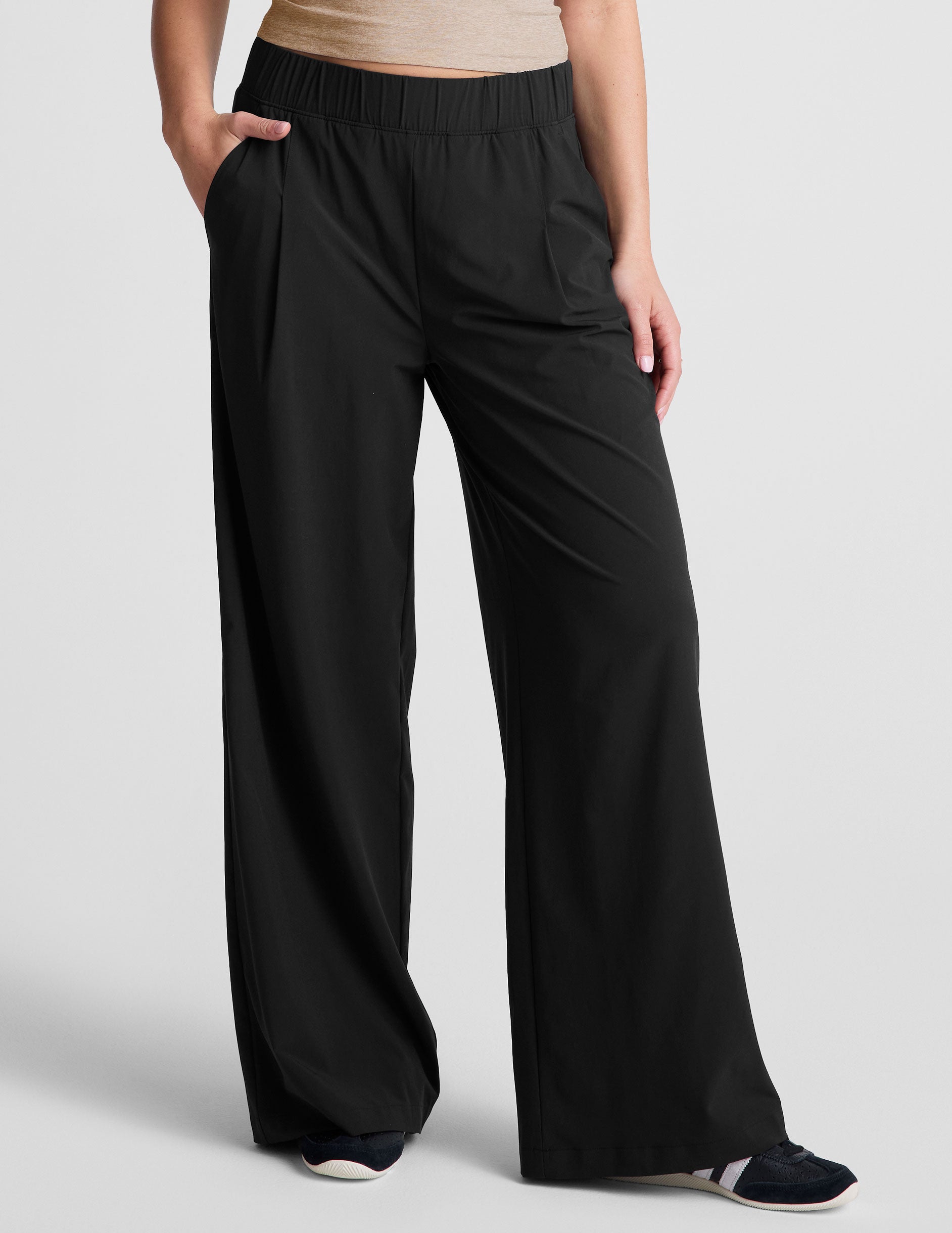 black mid rise relaxed fit wide leg pant with front side seam pockets and back pockets. 