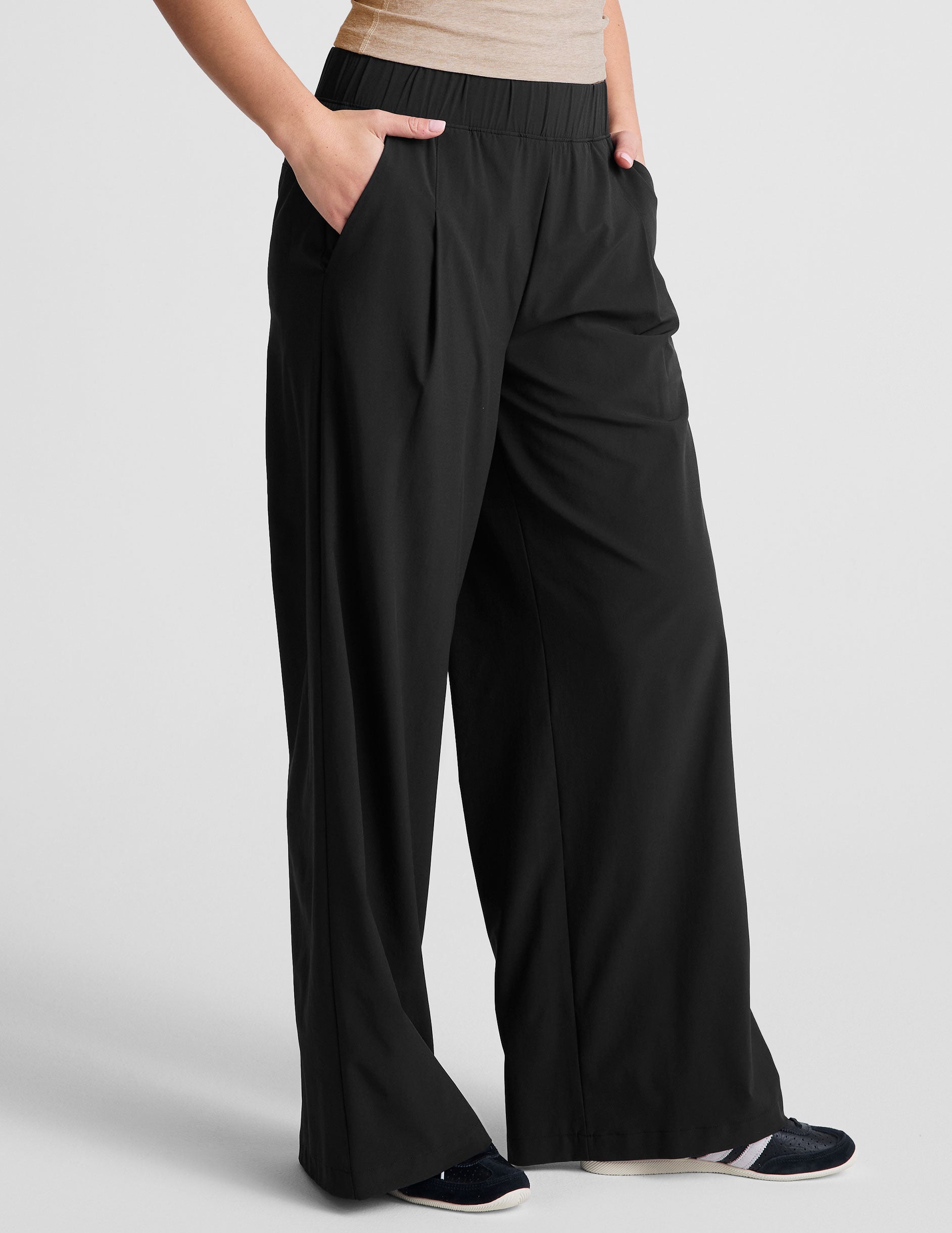 black mid rise relaxed fit wide leg pant with front side seam pockets and back pockets. 