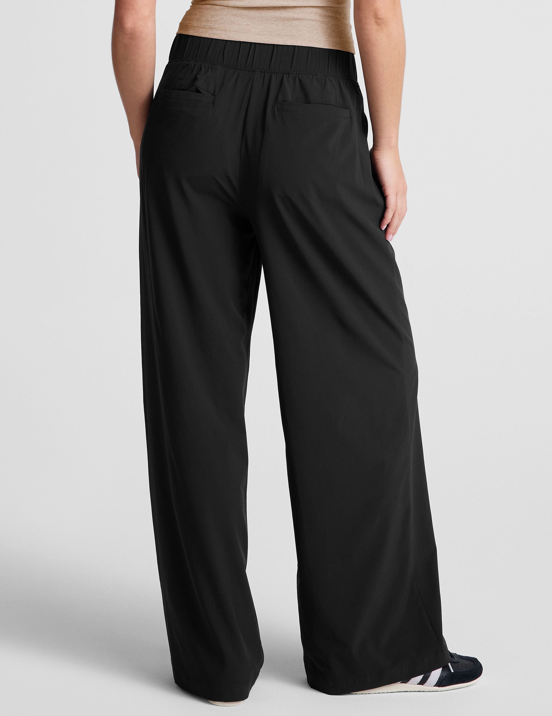 black mid rise relaxed fit wide leg pant with front side seam pockets and back pockets. 