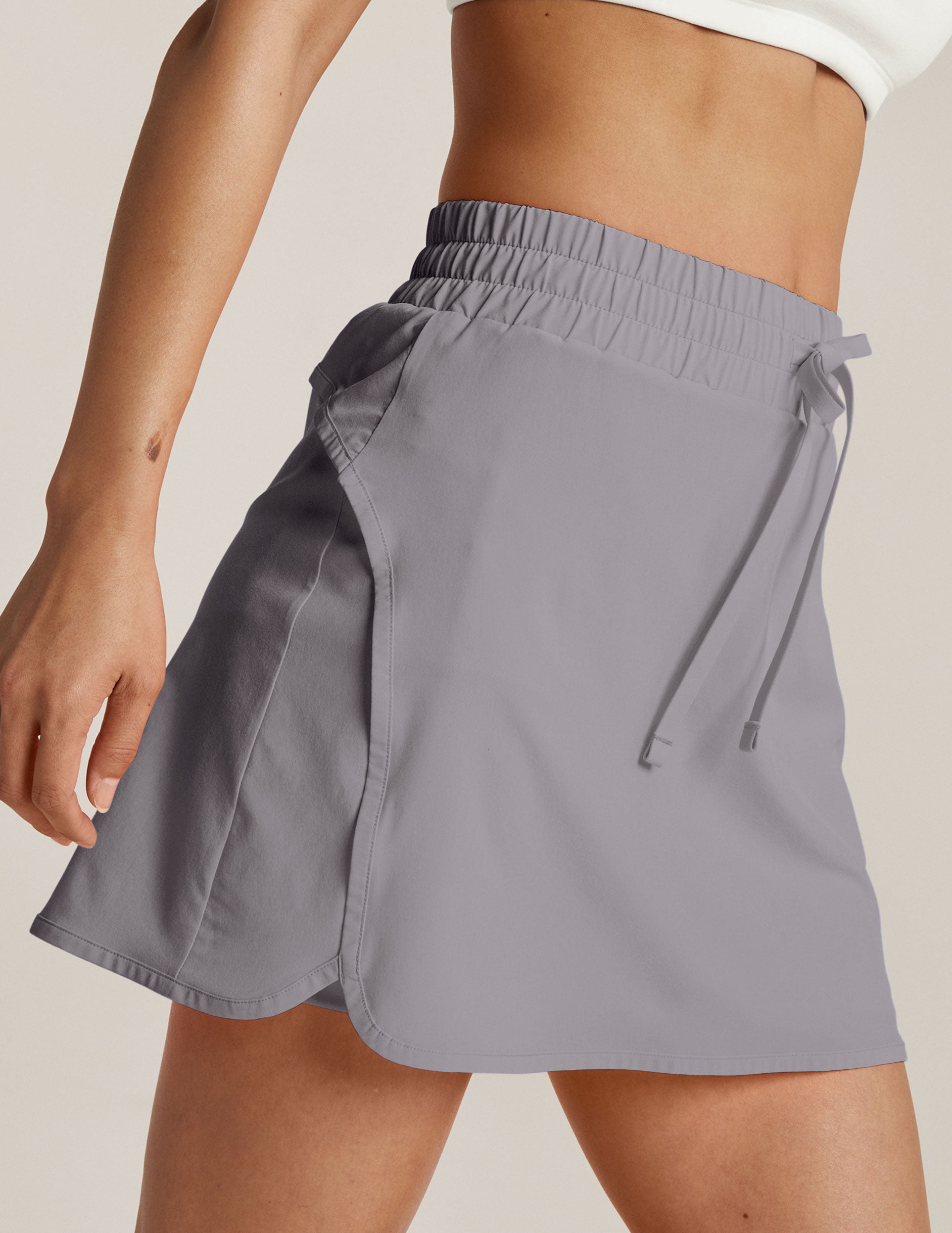 gray mini skirt with a drawstring at the waistband. 