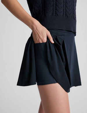 blue mini pleated skirt with interior shorts with pockets. 
