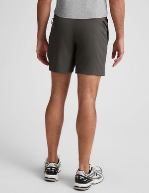 man wearing a gray t-shirt and graphite shorts on a white background. 