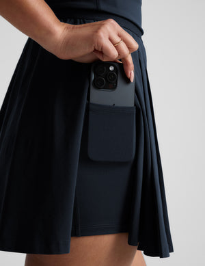 Woman wearing a blue dress against a plain background. 