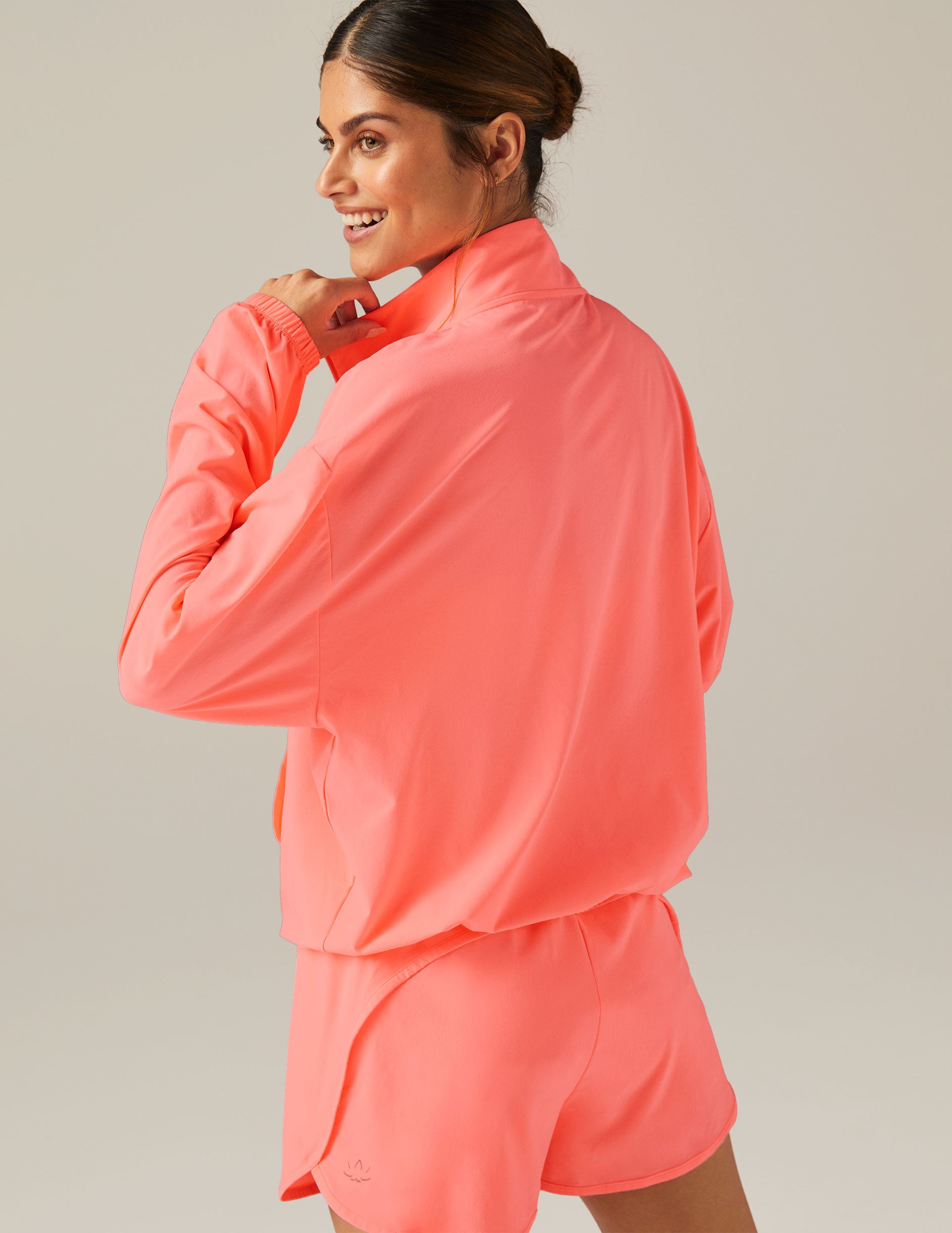 pink half zip jacket with kangaroo pockets at front
