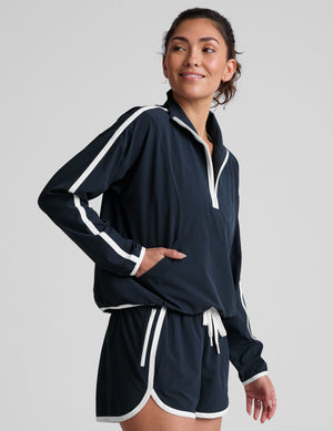 blue pullover with a half zip front​ and front kangaroo pocket​. 